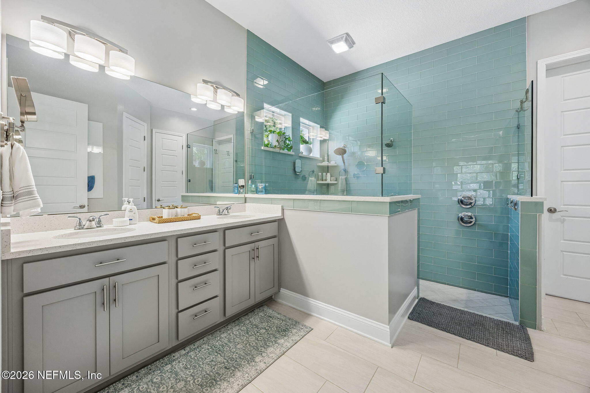 85949 Miner Pines Yulee, FL 32097 - Photo 21 of 55 a bathroom with a double vanity sink mirror and shower