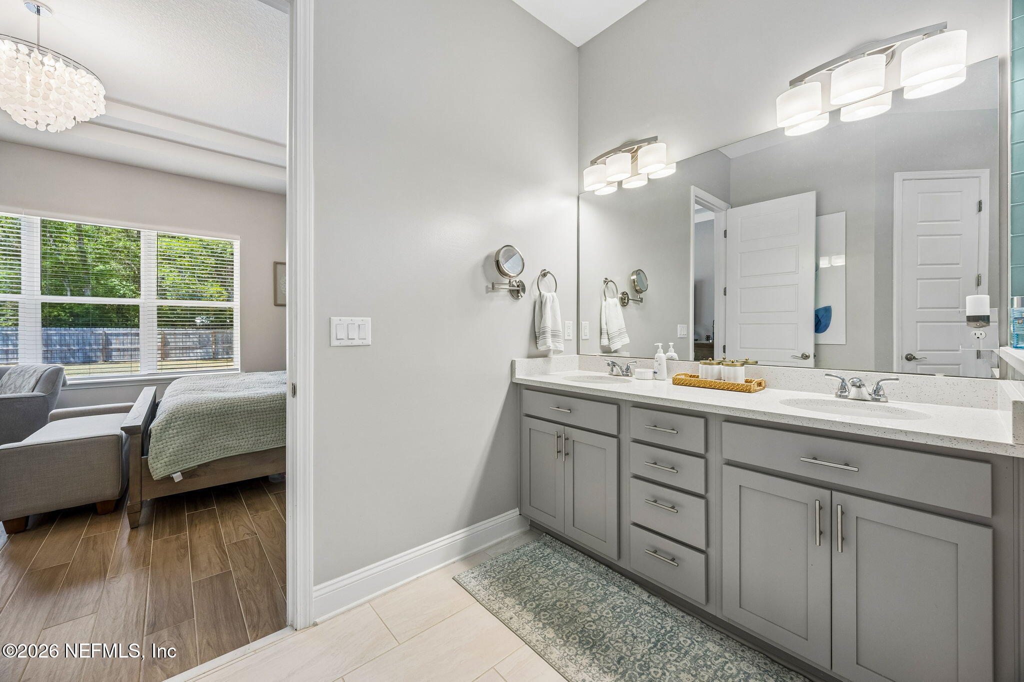 85949 Miner Pines Yulee, FL 32097 - Photo 23 of 55 a en suite bathroom with double vanity and a mirror