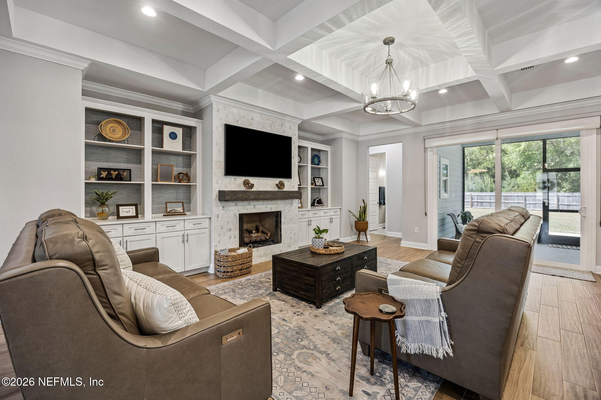 85949 Miner Pines Yulee, FL 32097 - Photo 2 of 55 a living room with furniture a fireplace and a flat screen tv
