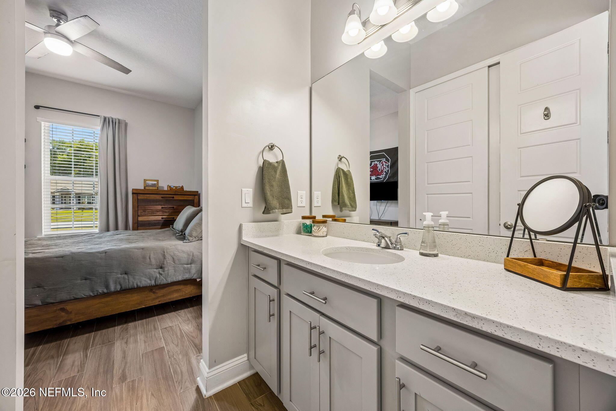 85949 Miner Pines Yulee, FL 32097 - Photo 30 of 55 a en suite bathroom with a double vanity sink a mirror and a bathtub