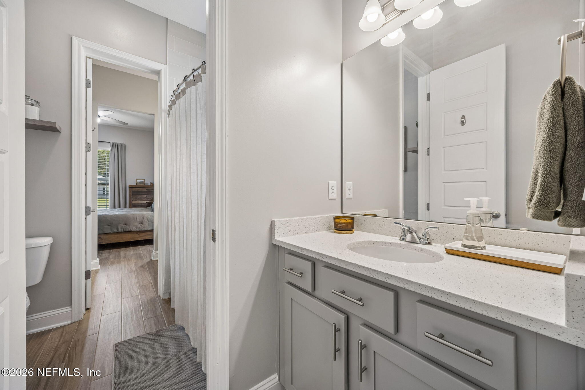 85949 Miner Pines Yulee, FL 32097 - Photo 31 of 55 a en suite bathroom with a sink a mirror and a shower