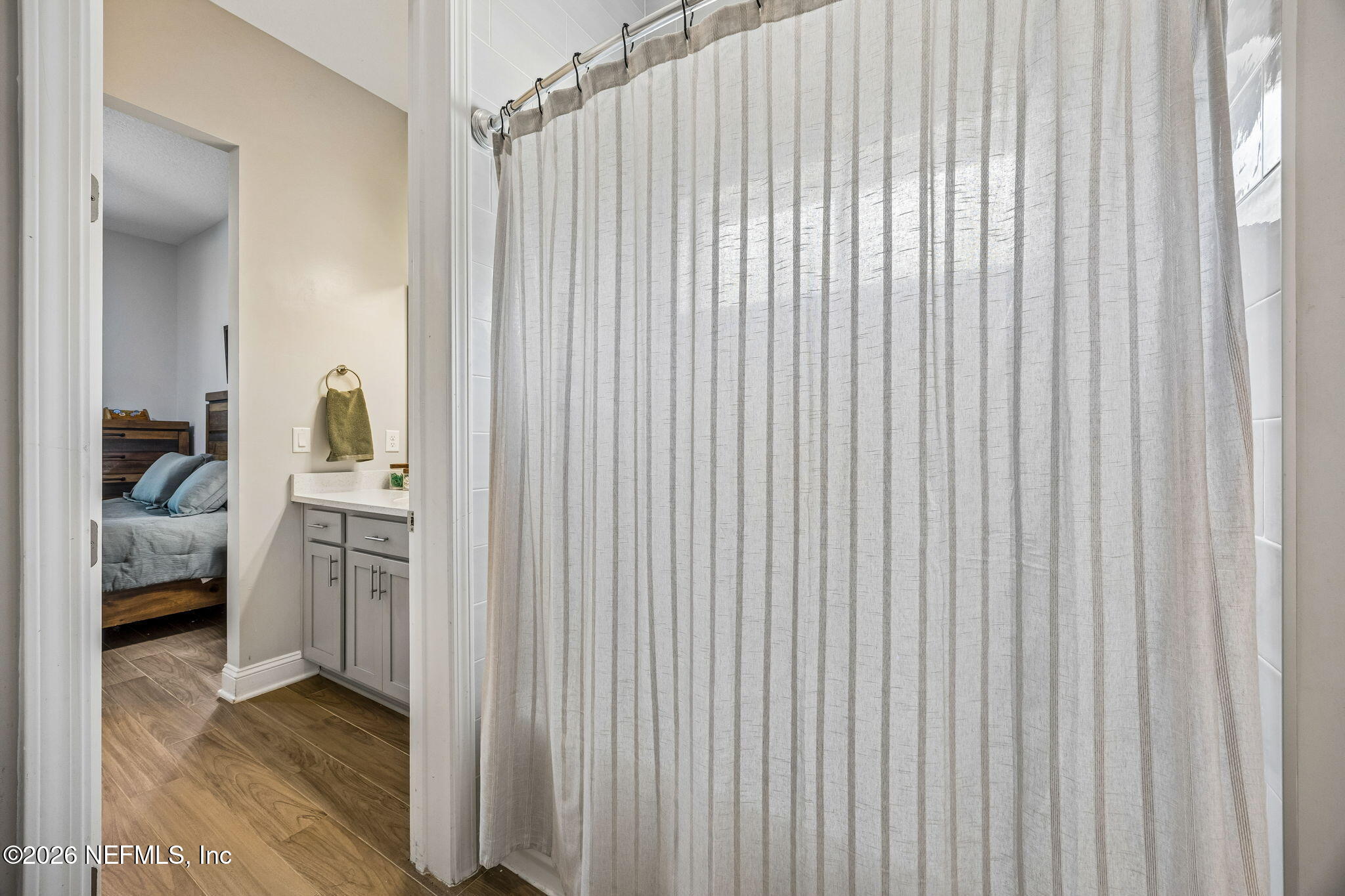 85949 Miner Pines Yulee, FL 32097 - Photo 32 of 55 a en suite bathroom with a granite countertop sink and a mirror