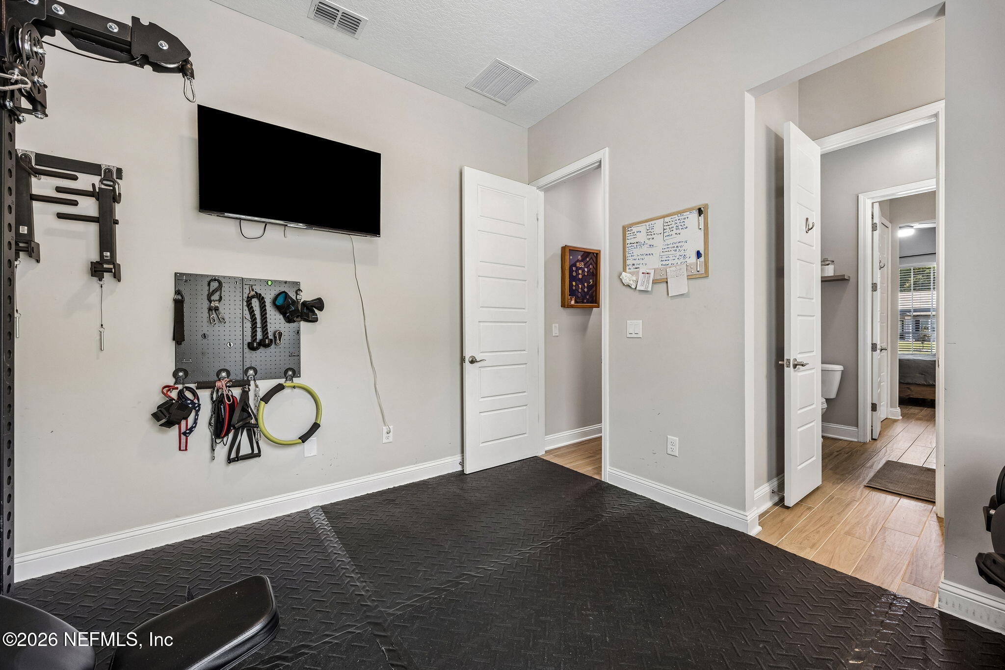 85949 Miner Pines Yulee, FL 32097 - Photo 35 of 55 a view of a livingroom with wooden floor and a flat screen tv