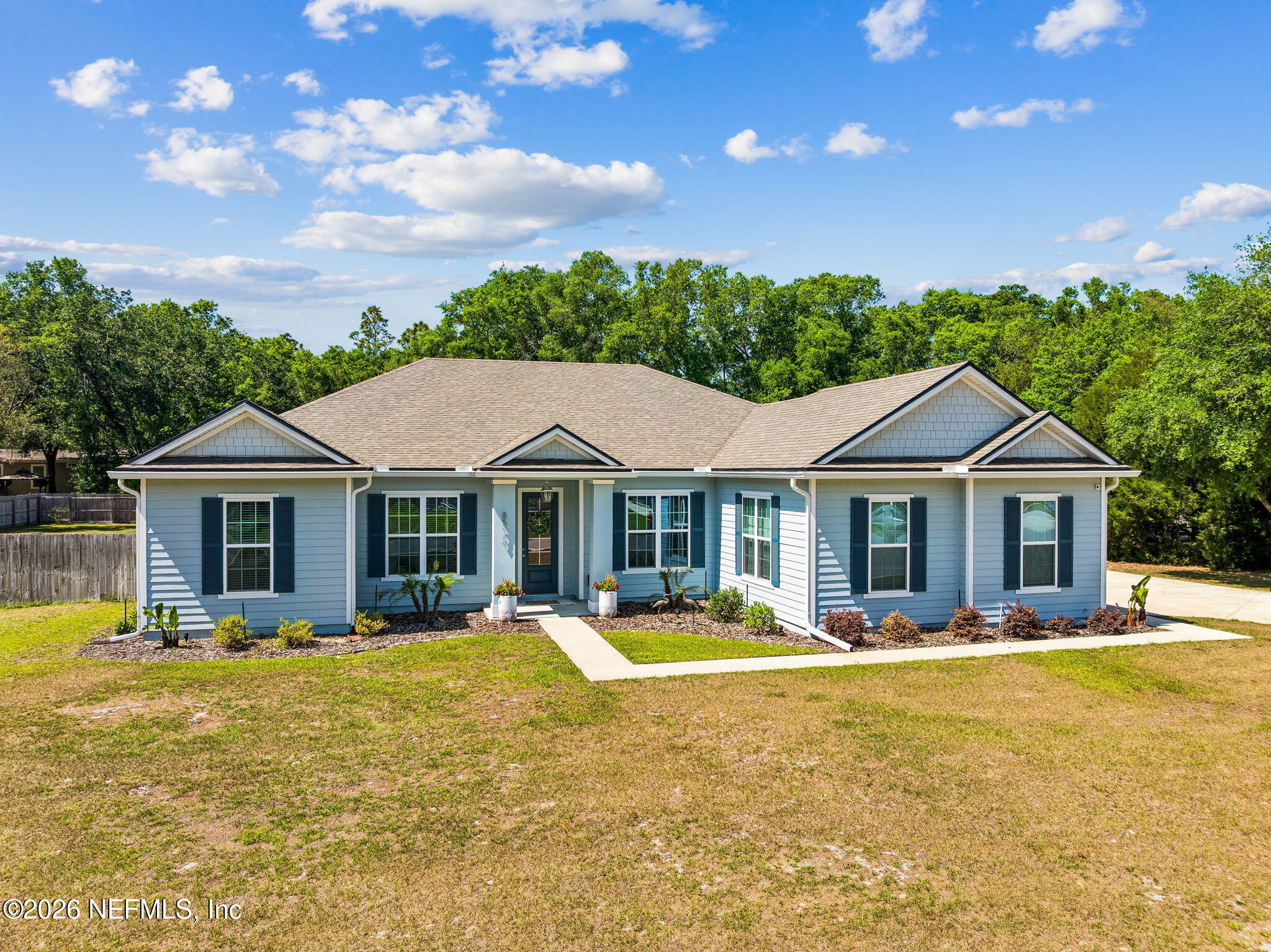 85949 Miner Pines Yulee, FL 32097 - Photo 54 of 55 a front view of a house with a yard table and chairs