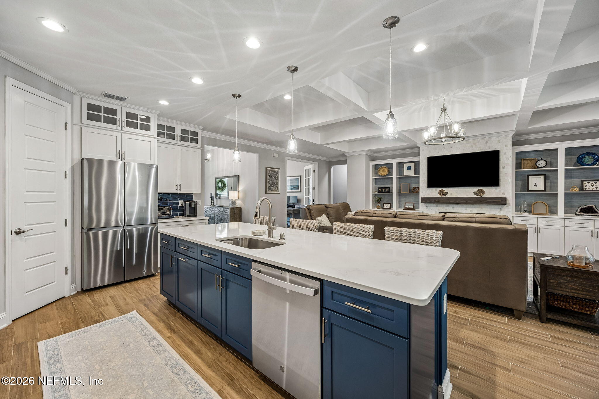 85949 Miner Pines Yulee, FL 32097 - Photo 6 of 55 a large kitchen with stainless steel appliances kitchen island granite countertop a large stove a sink dishwasher and a refrigerator with wooden floor