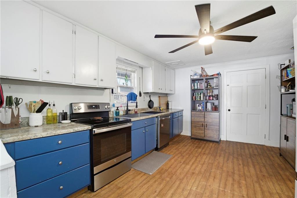 21 School Street Northeast Rydal, GA 30171 - Photo 13 of 44 a kitchen with stainless steel appliances granite countertop a refrigerator a sink dishwasher a stove and white cabinets with wooden floor