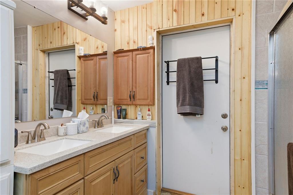 21 School Street Northeast Rydal, GA 30171 - Photo 20 of 44 a bathroom with a double vanity sink and mirror