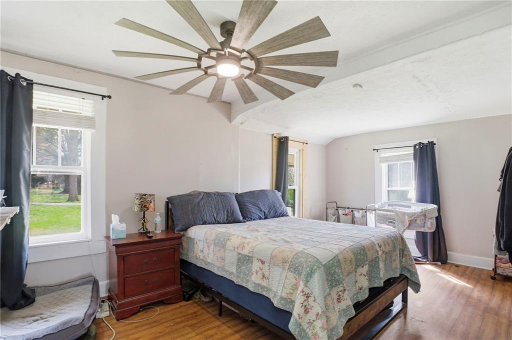 21 School Street Northeast Rydal, GA 30171 - Photo 24 of 44 a spacious bedroom with a bed and a chandelier