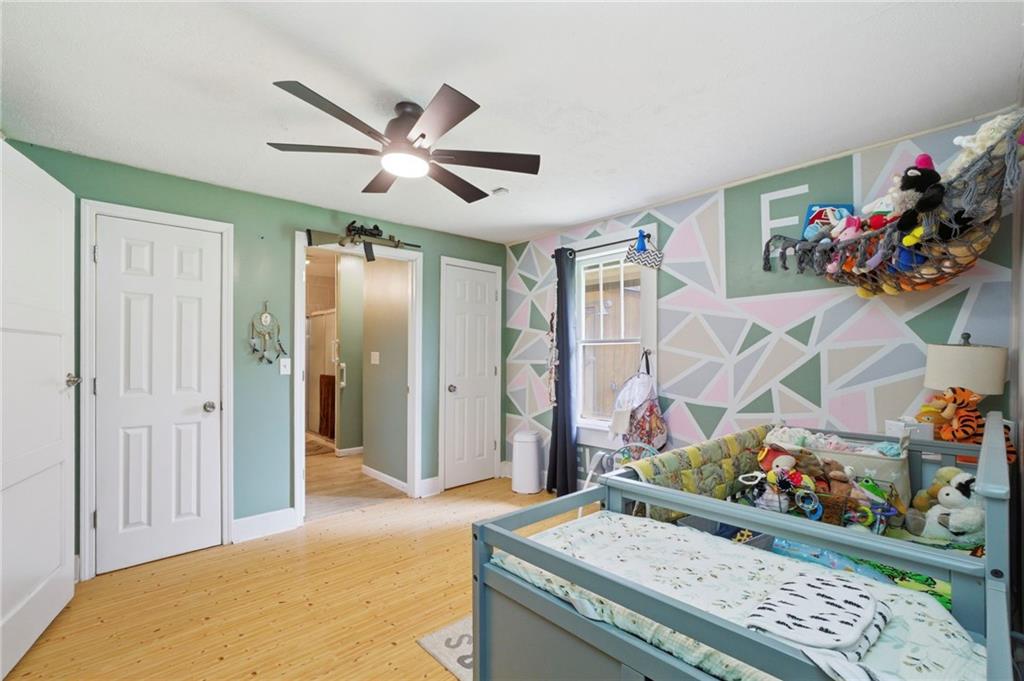 21 School Street Northeast Rydal, GA 30171 - Photo 28 of 44 a living room with a baby crib furniture and a window