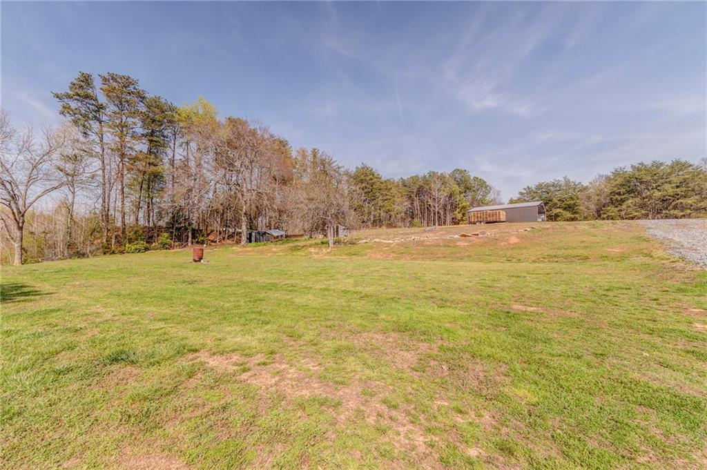 21 School Street Northeast Rydal, GA 30171 - Photo 38 of 44 a view of yard with ocean and trees in the background