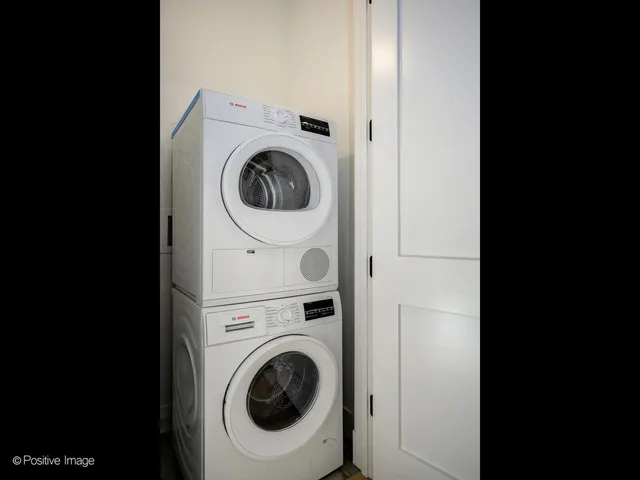 a view of a hallway with washer and dryer