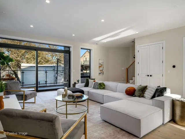 a living room with furniture and large windows
