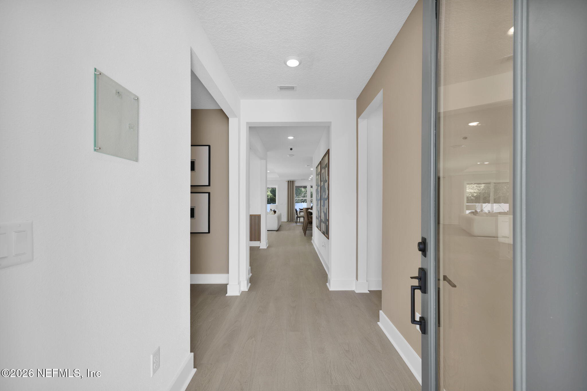 1739 Mickey Way Middleburg, FL 32068 - Photo 4 of 25 a view of a hallway with wooden floor and a bathroom