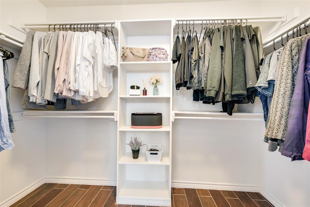 106 Villanova Circle Forney, TX 75126 - Photo 18 of 26 a view of walk in closet with clothes and shoes