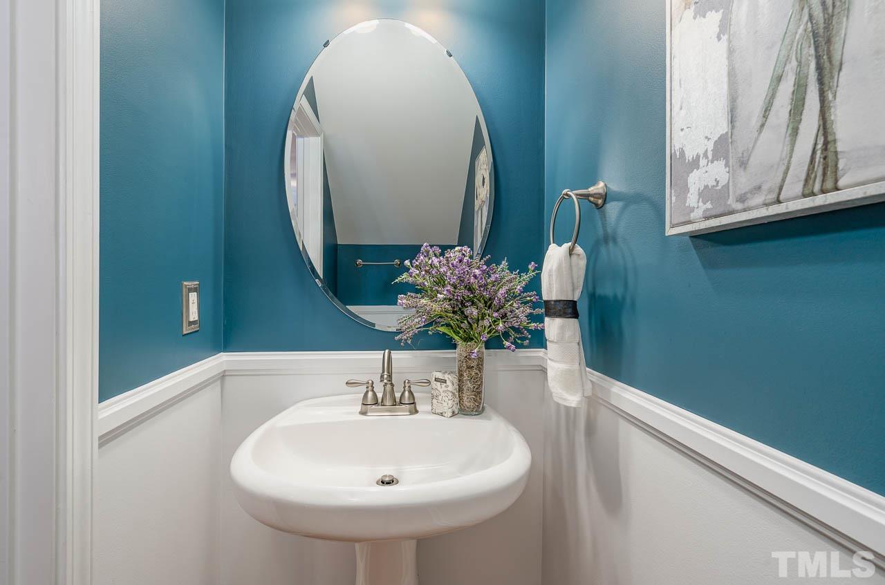 6022 Viking Drive Raleigh, NC 27612 - Photo 3 of 11 a bathroom with a sink and a mirror