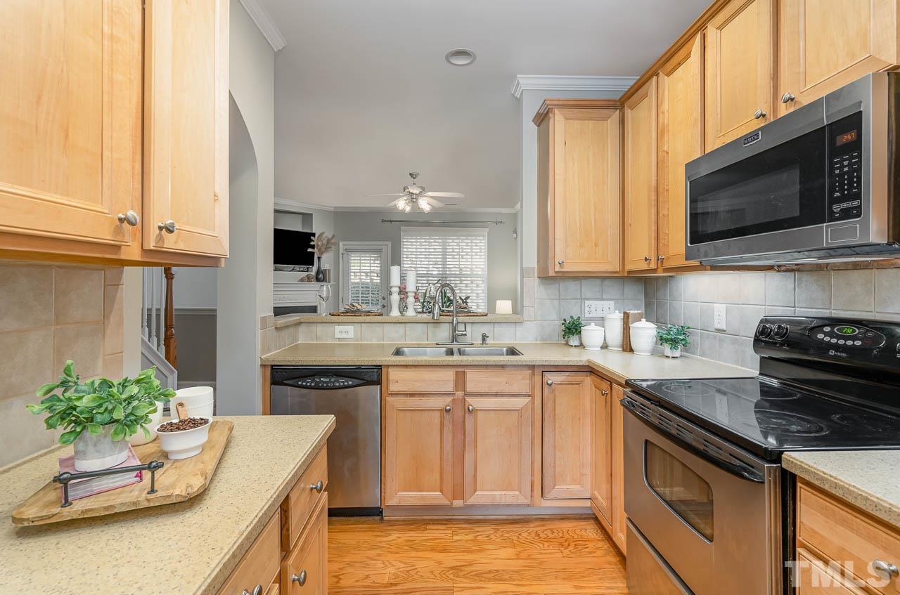 6022 Viking Drive Raleigh, NC 27612 - Photo 4 of 11 a kitchen with a sink stove and microwave