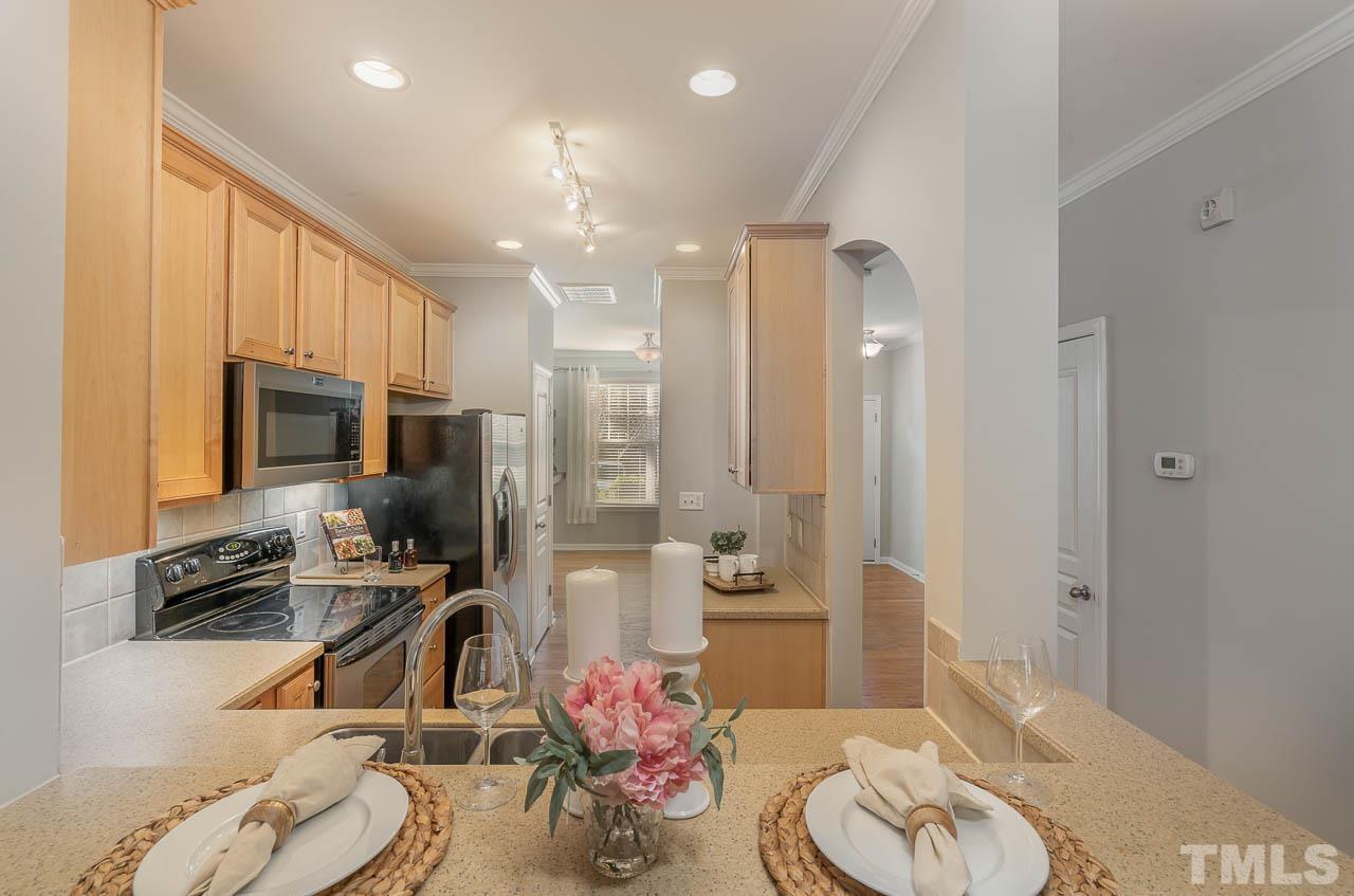 6022 Viking Drive Raleigh, NC 27612 - Photo 5 of 11 a kitchen with a sink stove and refrigerator