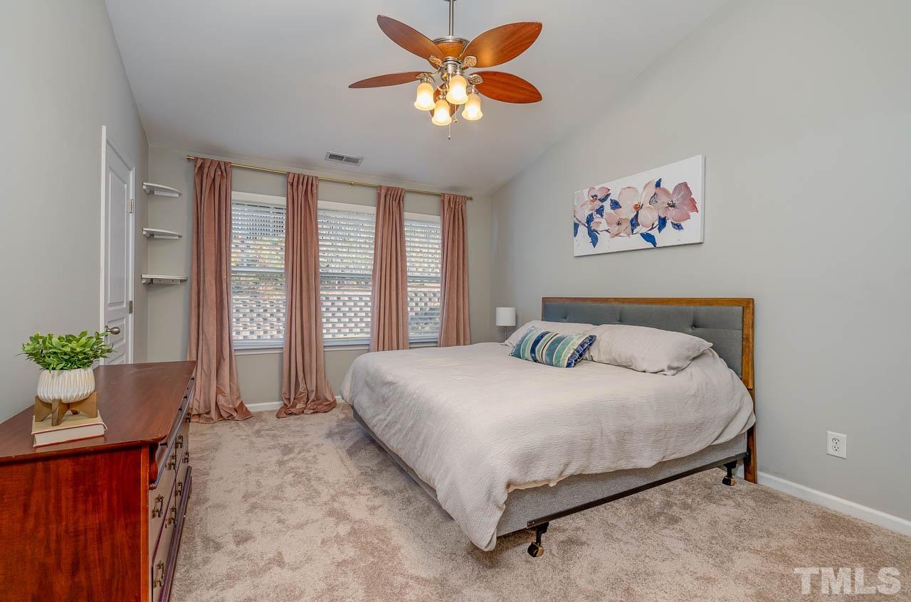 6022 Viking Drive Raleigh, NC 27612 - Photo 8 of 11 a large bed sitting in a bedroom next to a window