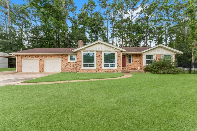 a front view of a house with a garden