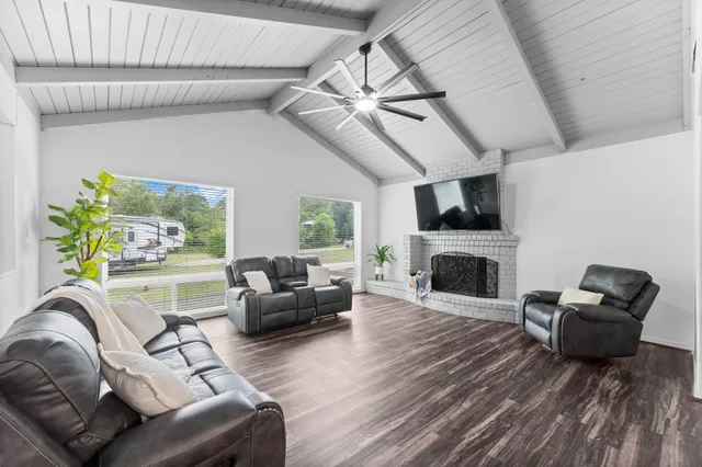 a living room with furniture fireplace and flat screen tv