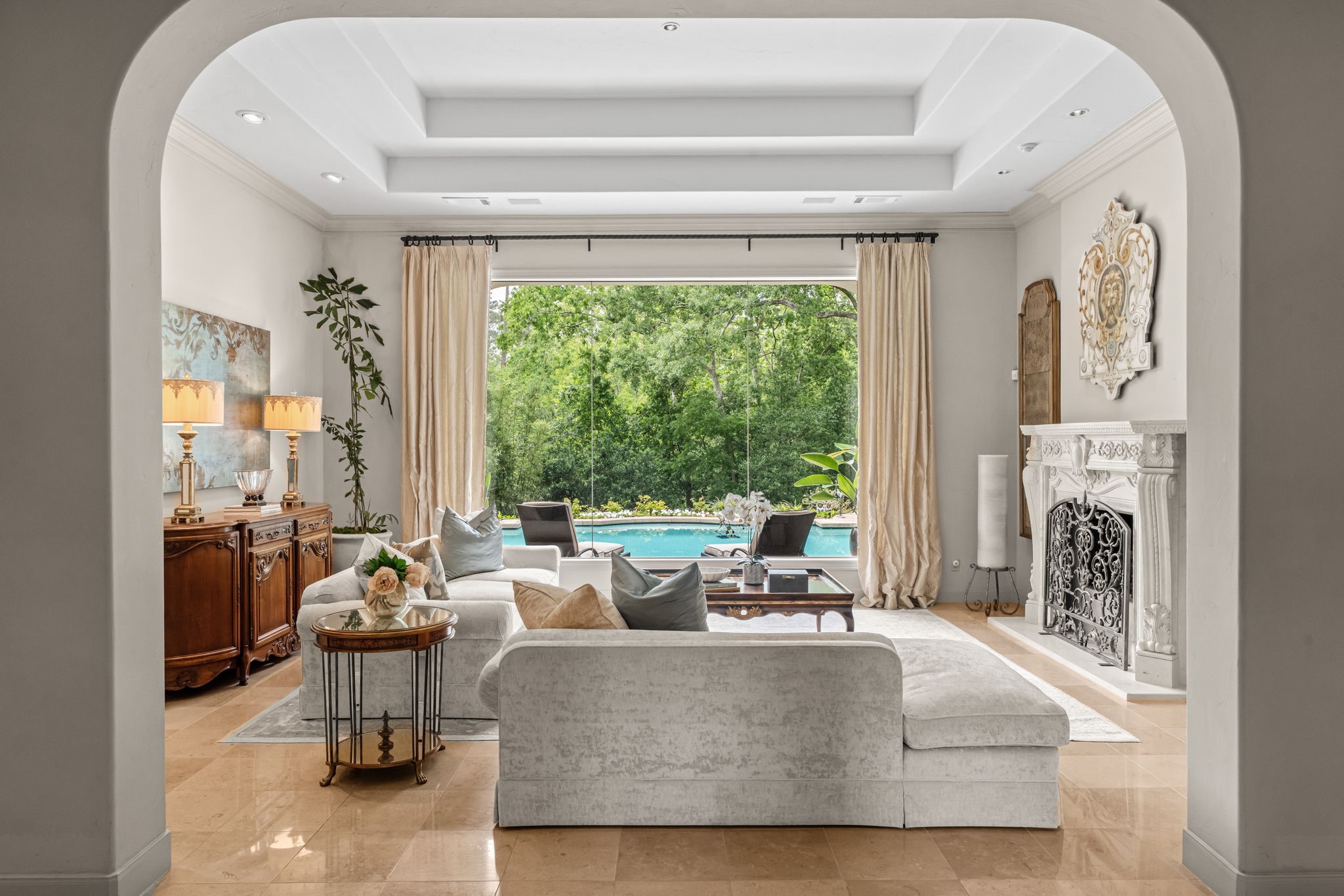 6 Mott Lane Houston, TX 77024 - Photo 13 of 50 Expansive windows frame serene pool and garden views, while soft neutral tones, custom drapery, and refined finishes create a sophisticated yet inviting space perfect for entertaining.