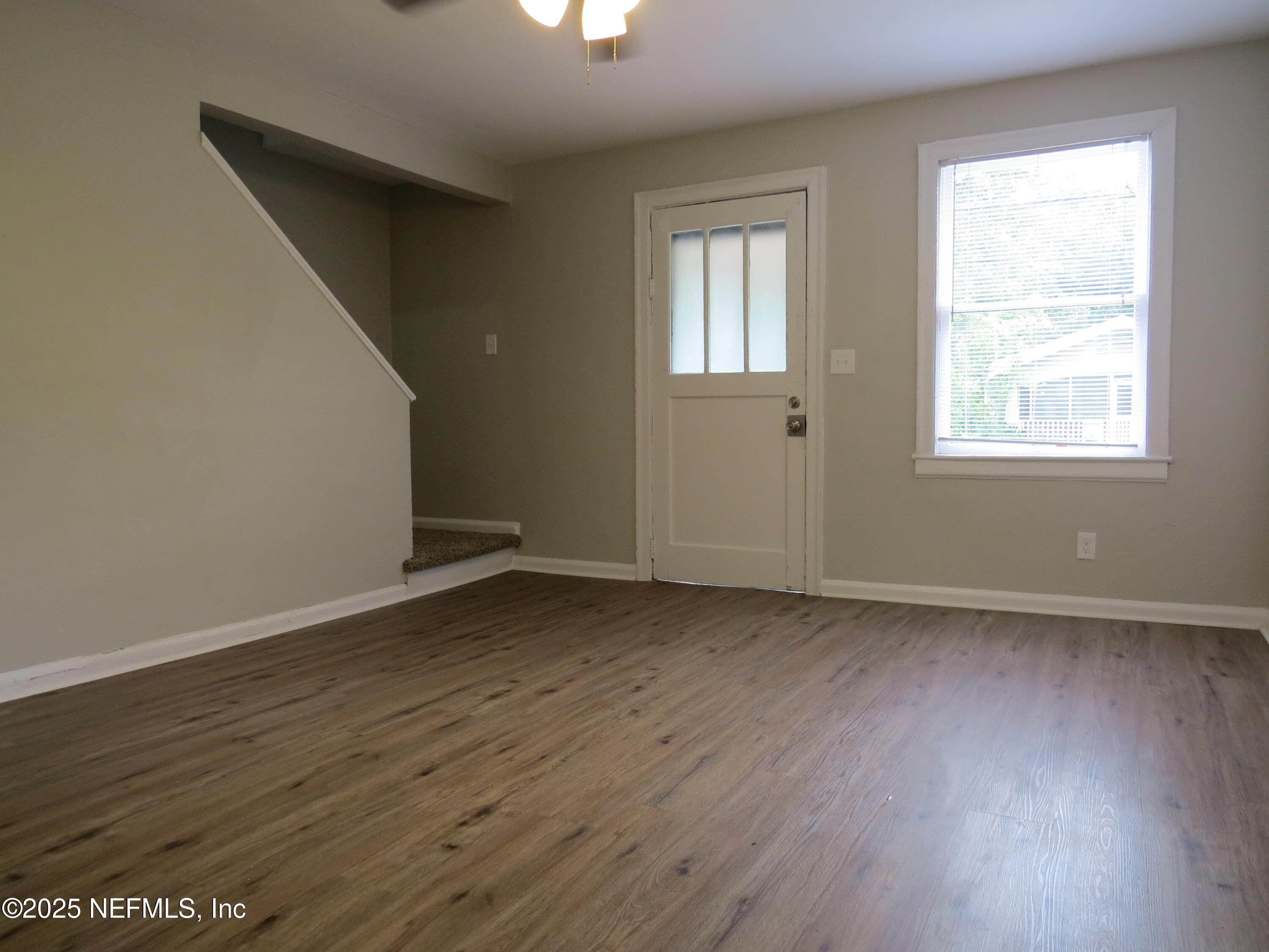 1204 Cherry Street Jacksonville, FL 32205 - Photo 11 of 32 an empty room with wooden floor and windows