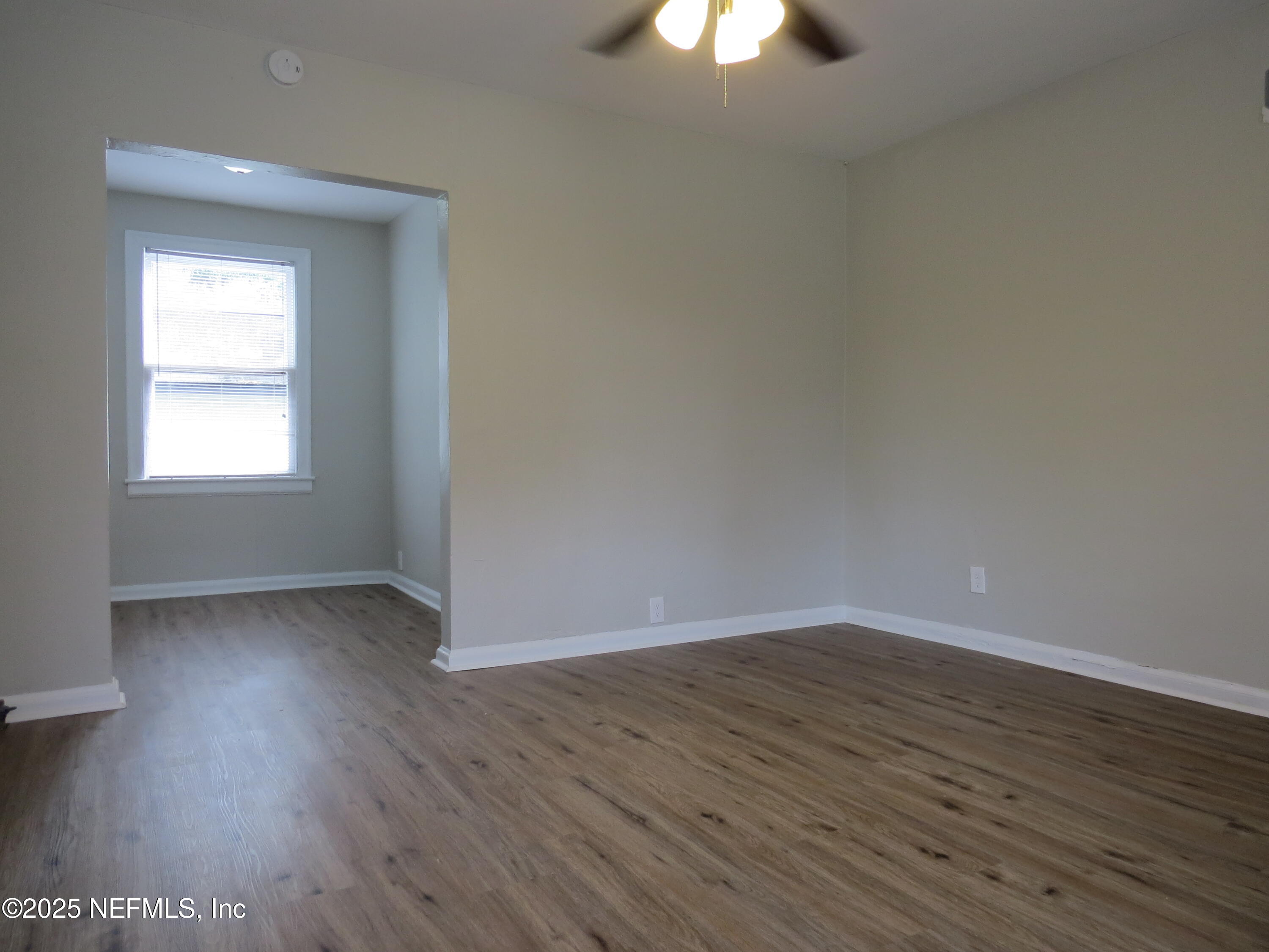 1204 Cherry Street Jacksonville, FL 32205 - Photo 12 of 32 an empty room with wooden floor cabinet and windows