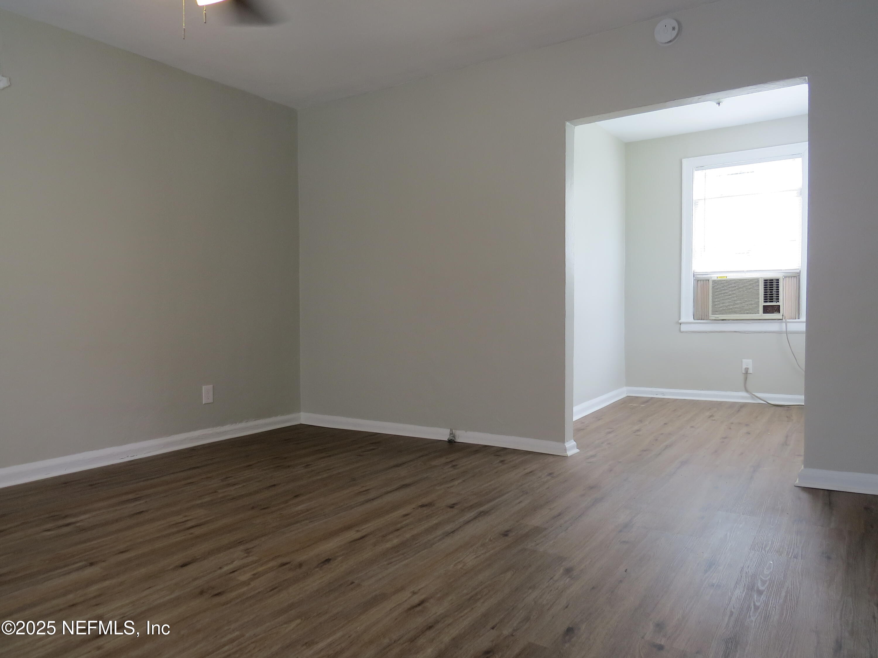 1204 Cherry Street Jacksonville, FL 32205 - Photo 13 of 32 a view of an empty room with wooden floor and a window