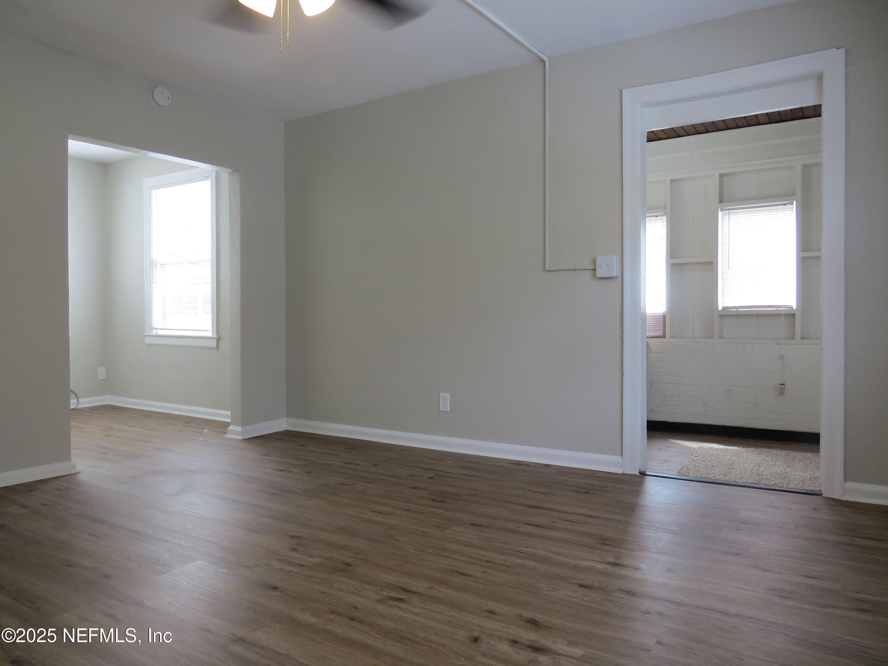 1204 Cherry Street Jacksonville, FL 32205 - Photo 14 of 32 an empty room with wooden floor and windows