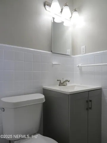 a bathroom with a sink a mirror and a toilet