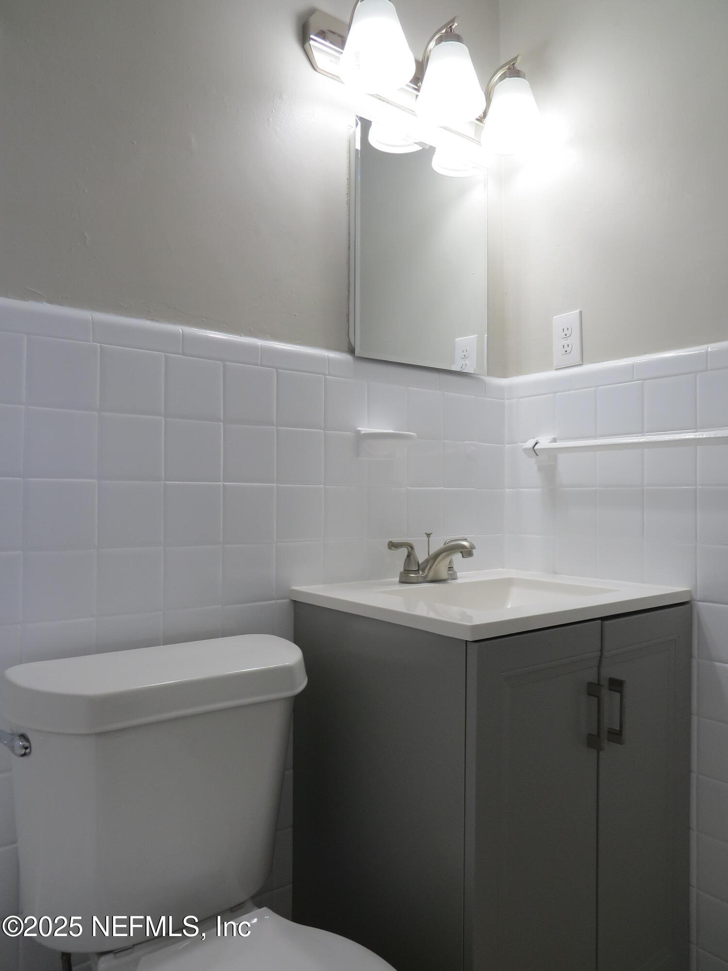 1204 Cherry Street Jacksonville, FL 32205 - Photo 19 of 32 a bathroom with a sink a toilet and mirror