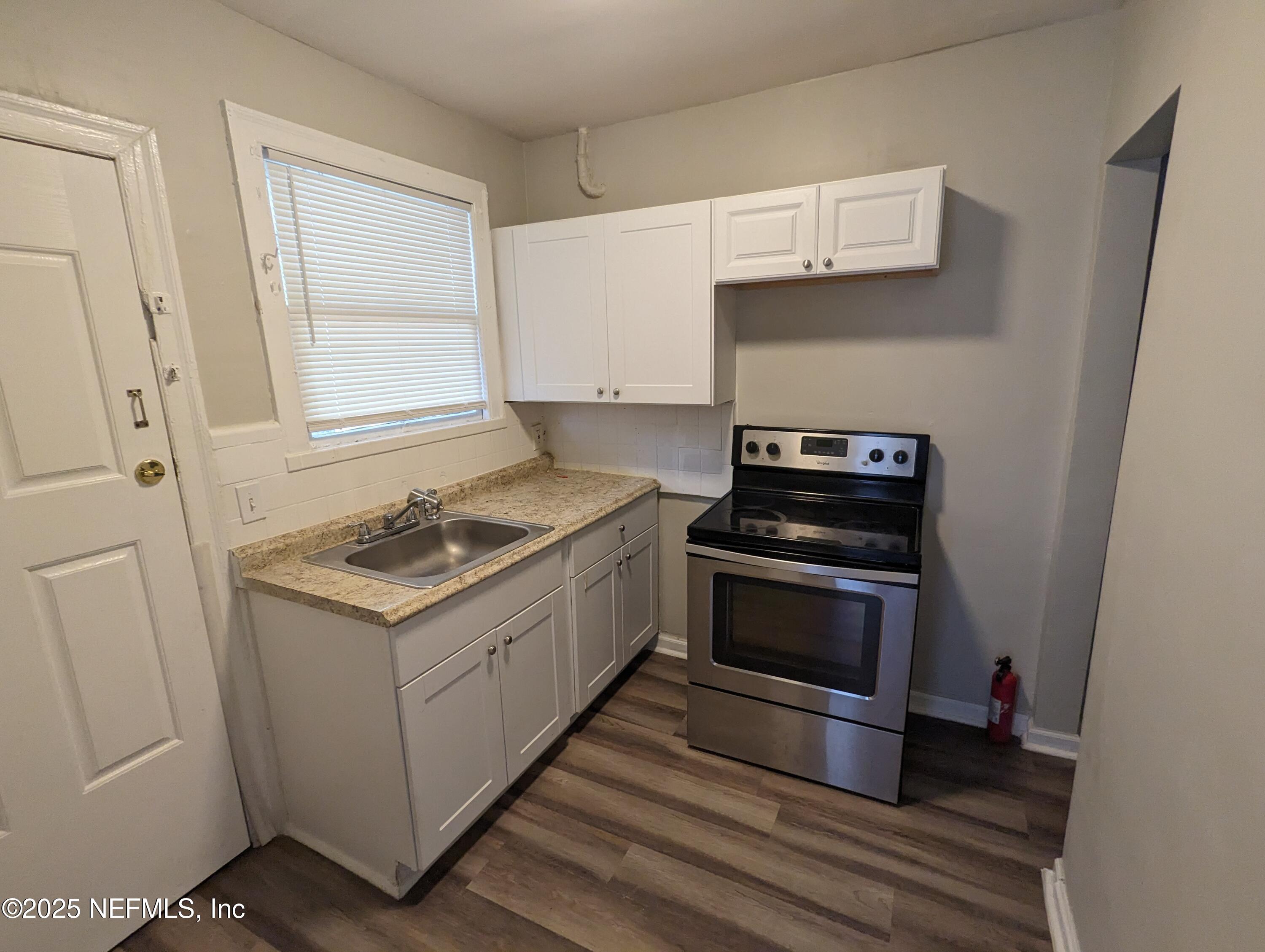 1204 Cherry Street Jacksonville, FL 32205 - Photo 24 of 32 a kitchen with a stove and a microwave
