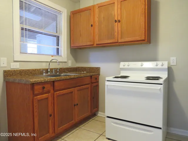 a kitchen with sink cabinets and window