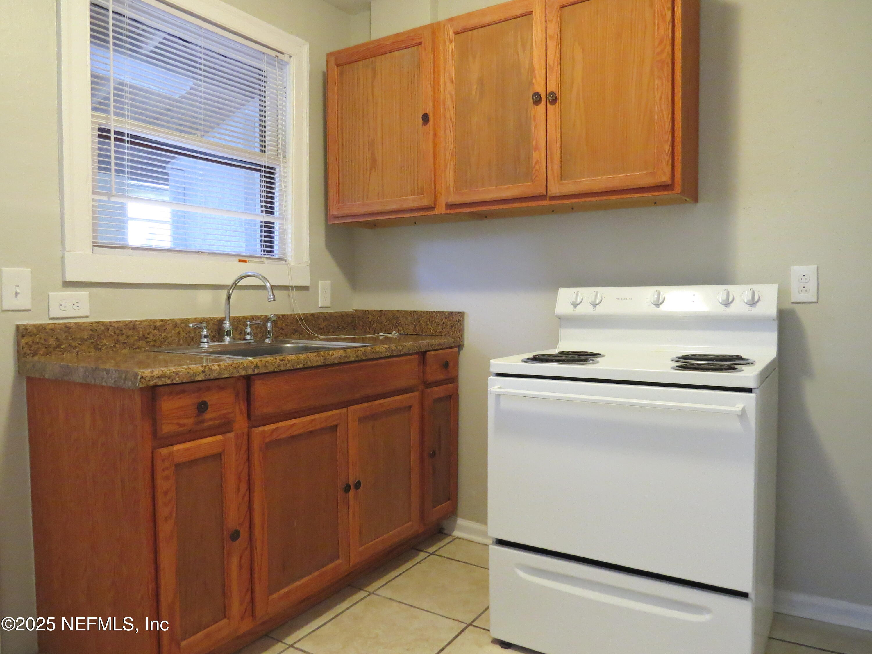 1204 Cherry Street Jacksonville, FL 32205 - Photo 9 of 32 a kitchen with granite countertop cabinets stainless steel appliances and a sink