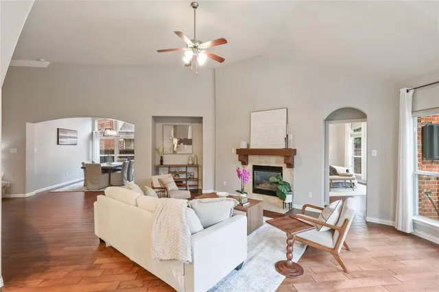 a living room with furniture a fireplace and a window