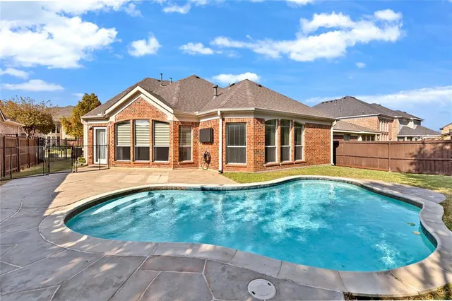 a view of a house with swimming pool and sitting area