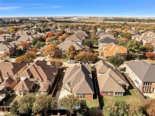 an aerial view of a house with a yard and a wooden deck