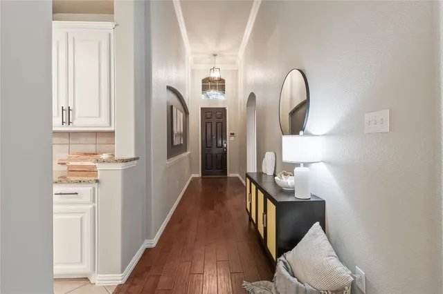 a floor to ceiling window with wooden floor