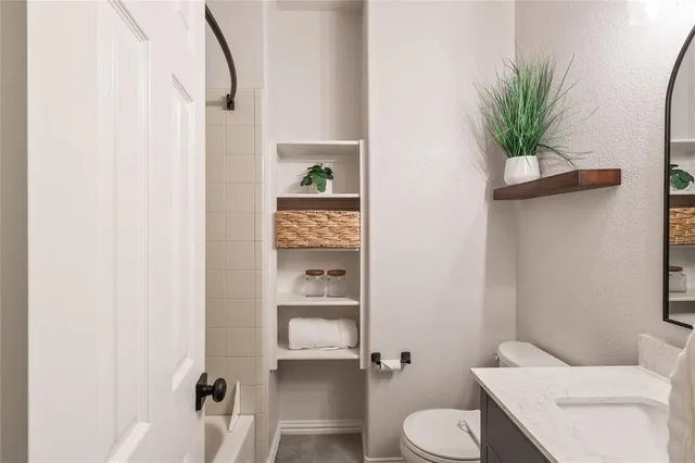 a bathroom with a toilet and a shower curtain
