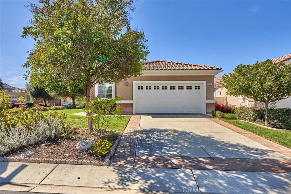1143 Saguara Road Beaumont, CA 92223 - Photo 10 of 66 a front view of a building with garden