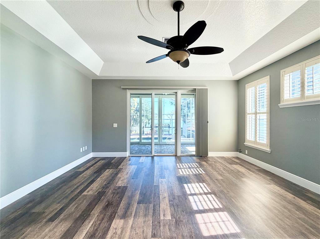 5243 West Lake Butler Road Windermere, FL 34786 - Photo 17 of 43 a view of an empty room with wooden floor and a window