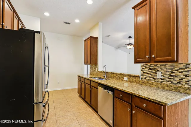 a bathroom with a sink double vanity granite and a mirror
