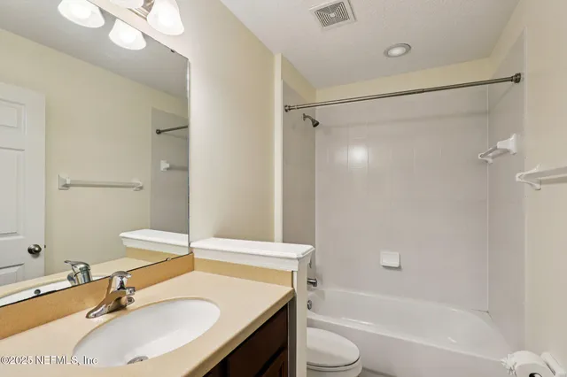 an empty room with a window and a ceiling fan