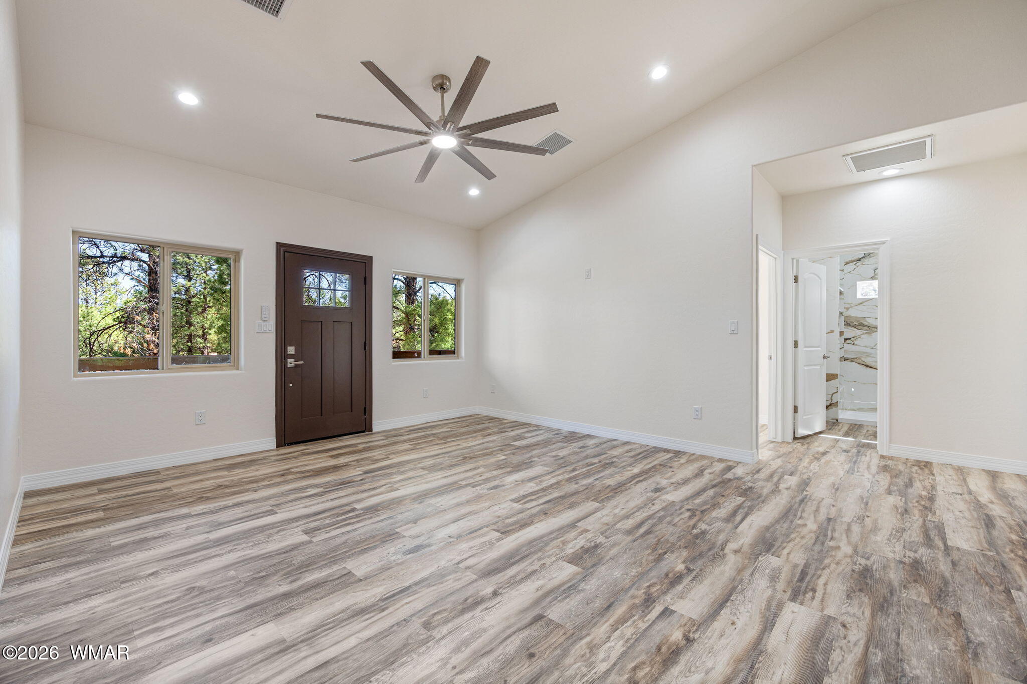 2273 Constellation Lane Overgaard, AZ 85933 - Photo 9 of 31 wooden floor in an empty room with a window