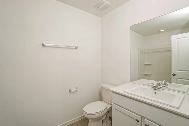 a view of a house with a yard and a large tree