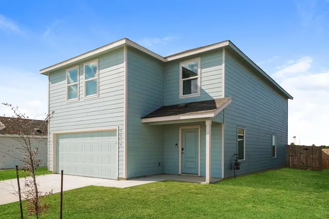 an empty room with windows and ceiling fan view