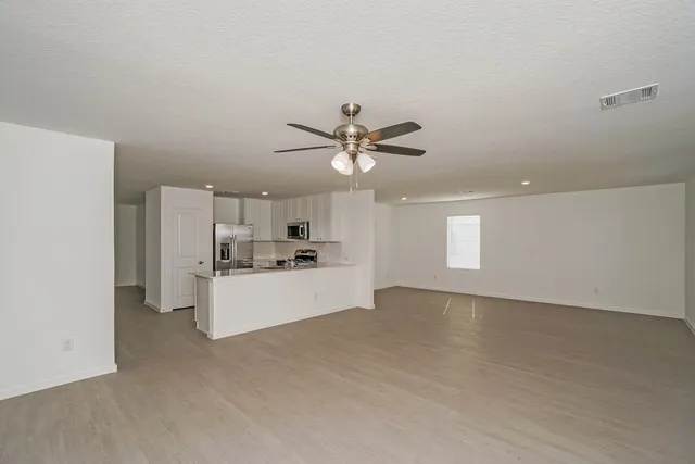 a kitchen with kitchen island sink stove and refrigerator