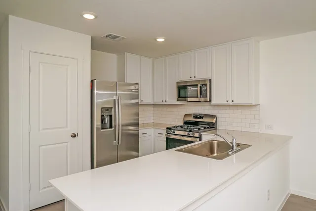an empty room with a ceiling fan and a window