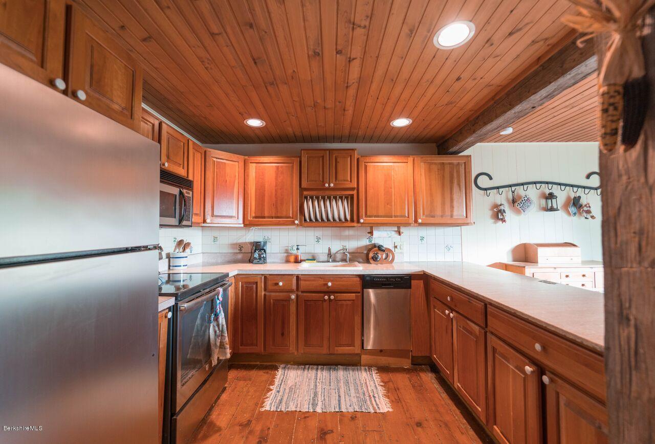 274 Bates Road Windsor, MA 01270 - Photo 14 of 44 a kitchen with stainless steel appliances granite countertop sink refrigerator and cabinets