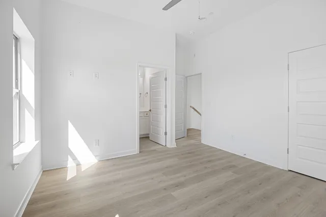 a bedroom with a bed and a large window